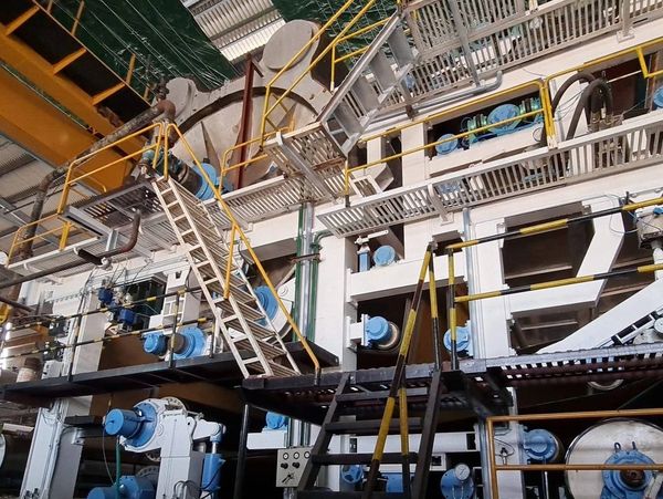 Industrial facility with multiple staircases and machinery.